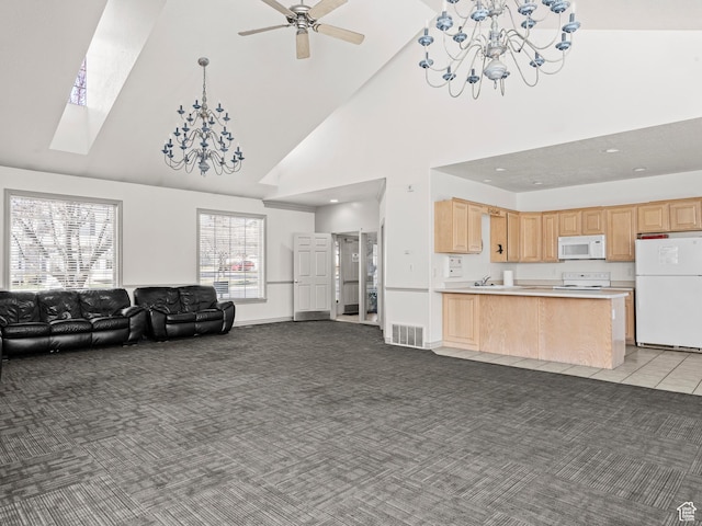 932 Independence Ave, Provo, UT 84604 - carpeted living room with high vaulted ceiling, a sink, a skylight, ceiling fan with notable chandelier, and visible vents