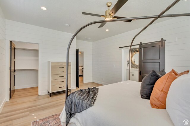 813 S 1260 W Unit 111, Heber City, UT 84032 - bedroom featuring a ceiling fan, a barn door, wood finished floors, a spacious closet, and recessed lighting