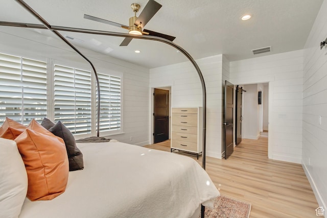 813 S 1260 W Unit 111, Heber City, UT 84032 - bedroom featuring light wood-style flooring, visible vents, wooden walls, recessed lighting, and a ceiling fan