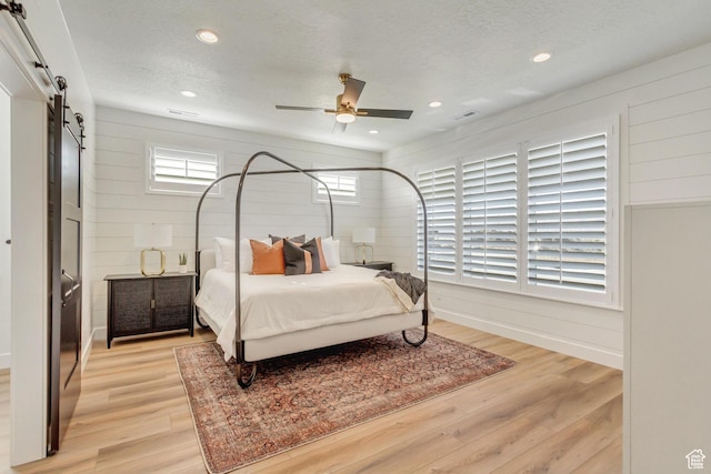 813 S 1260 W Unit 111, Heber City, UT 84032 - bedroom with a textured ceiling, visible vents, recessed lighting, a barn door, and light wood-style floors