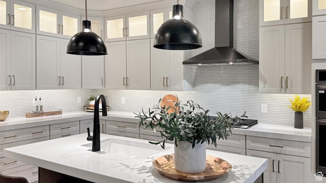 813 S 1260 W Unit 111, Heber City, UT 84032 - kitchen featuring wall chimney range hood, a sink, and tasteful backsplash