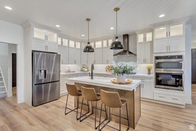 813 S 1260 W Unit 111, Heber City, UT 84032 - kitchen featuring light countertops, a kitchen island with sink, stainless steel appliances, a sink, and wall chimney range hood