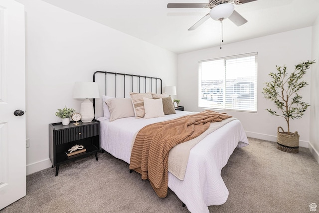 bedroom featuring baseboards, carpet flooring, and a ceiling fan