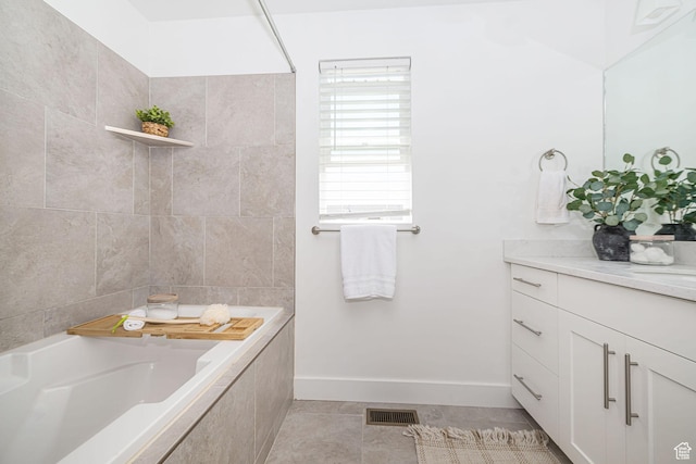 bathroom featuring baseboards, visible vents, tile patterned floors, and vanity
