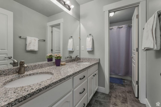 11773 S Twin Pines Ct, Draper, UT 84020 - bathroom with double vanity, a sink, and baseboards