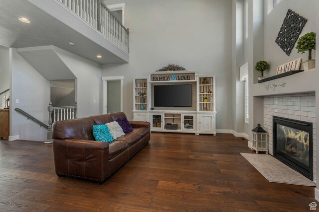 11773 S Twin Pines Ct, Draper, UT 84020 - living room with recessed lighting, baseboards, a high ceiling, hardwood / wood-style flooring, and a fireplace