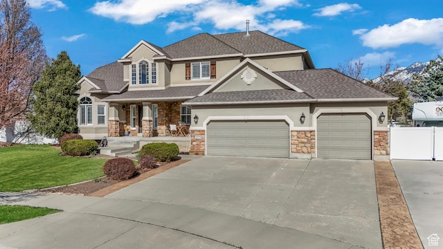 view of front facade featuring stucco siding, an attached garage, stone siding, and fence