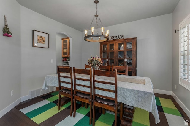 11773 S Twin Pines Ct, Draper, UT 84020 - dining room featuring plenty of natural light, baseboards, arched walkways, visible vents, and a notable chandelier