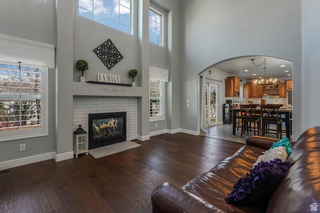 11773 S Twin Pines Ct, Draper, UT 84020 - living area with arched walkways, dark wood-style flooring, and a healthy amount of sunlight
