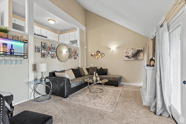 carpeted living room featuring lofted ceiling and baseboards