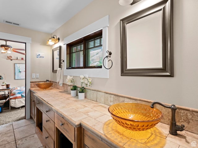 full bathroom with tile patterned floors, double vanity, ceiling fan, a sink, and visible vents