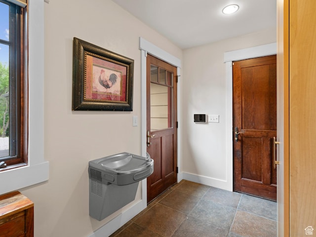 interior space featuring baseboards and a wealth of natural light