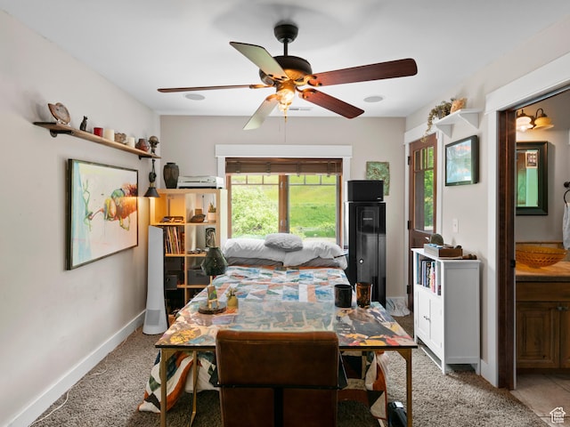 dining room featuring baseboards, a wealth of natural light, a ceiling fan, and carpet flooring