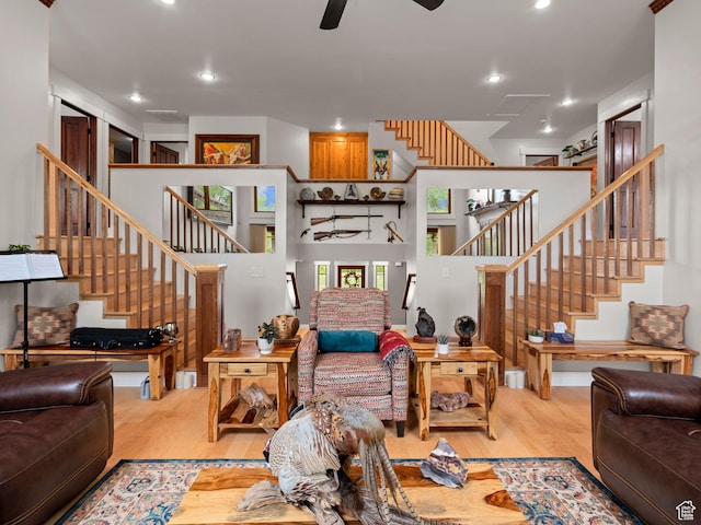 living room with stairway, wood finished floors, a ceiling fan, and recessed lighting