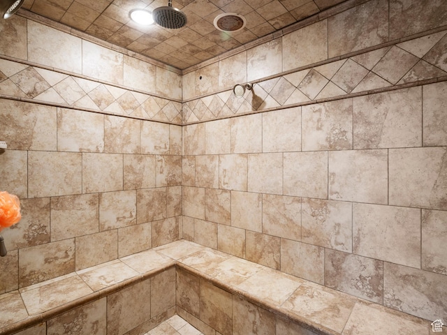 interior details featuring tiled shower