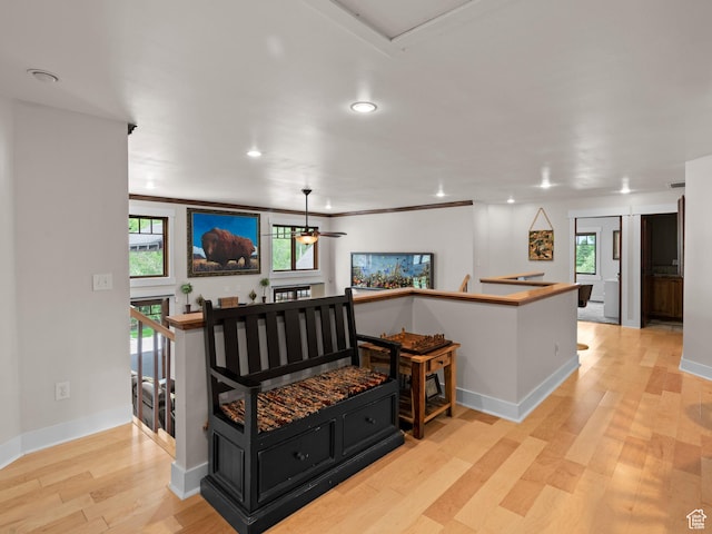 interior space with an upstairs landing, light wood-style floors, plenty of natural light, and recessed lighting
