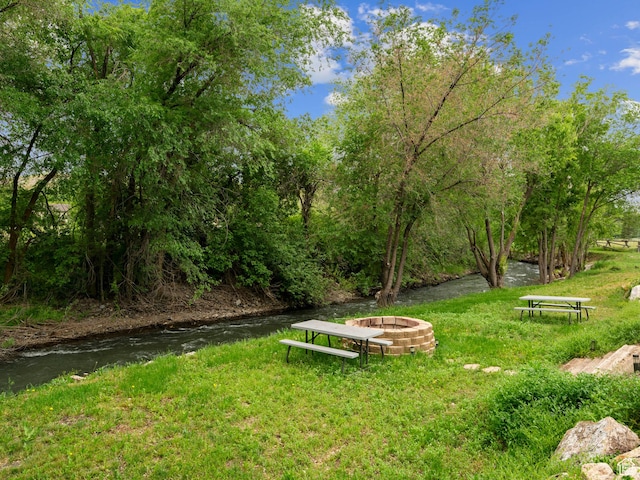 view of yard featuring an outdoor fire pit