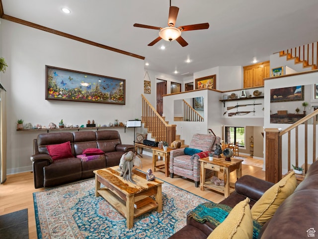living area featuring crown molding, stairway, ceiling fan, light wood-type flooring, and recessed lighting