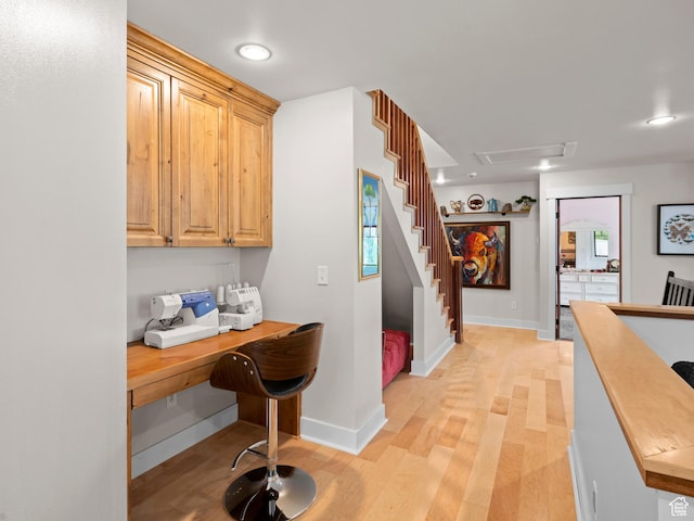hall with light wood finished floors, stairs, recessed lighting, and baseboards