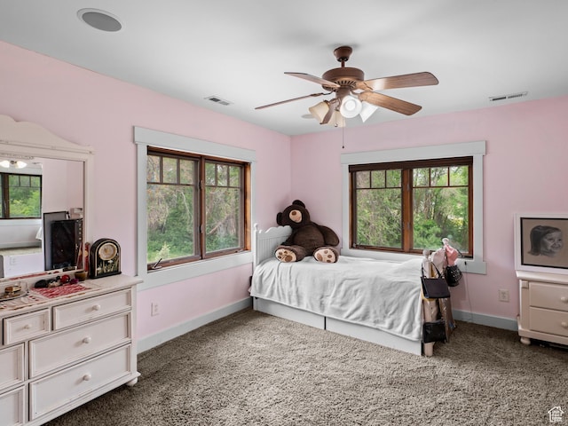 carpeted bedroom with visible vents, ceiling fan, and baseboards