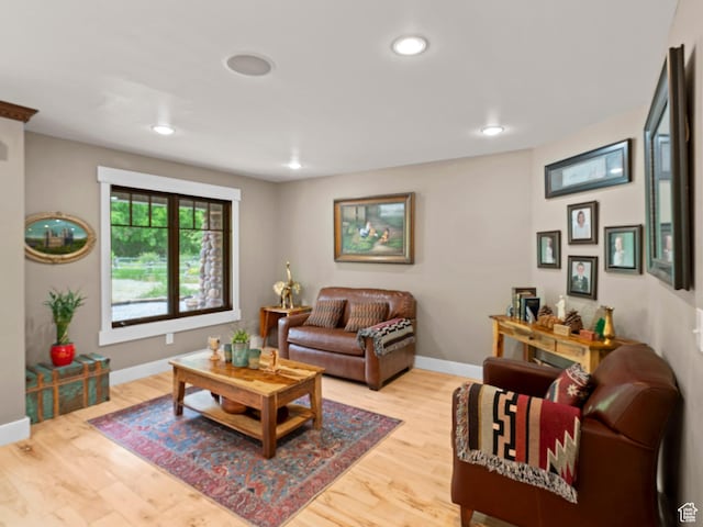 living area with wood finished floors, recessed lighting, and baseboards