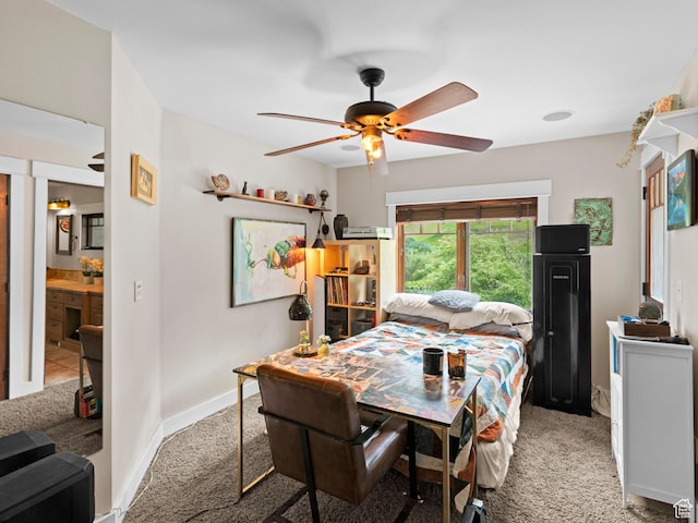 dining space featuring baseboards, a ceiling fan, and light colored carpet