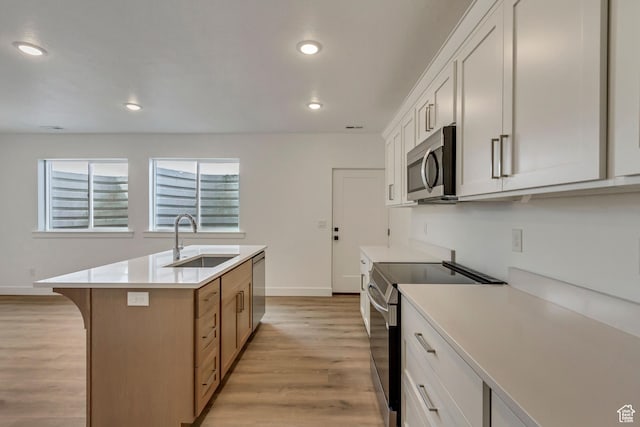 8077 N Bristle Cone Rd, Eagle Mountain, UT 84005 - kitchen featuring light countertops, recessed lighting, a sink, light wood-style flooring, and appliances with stainless steel finishes