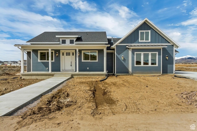 8077 N Bristle Cone Rd, Eagle Mountain, UT 84005 - view of front of home featuring a shingled roof, a porch, and board and batten siding