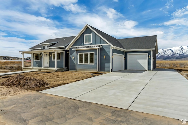 view of front of home with a porch, board and batten siding, concrete driveway, and a garage