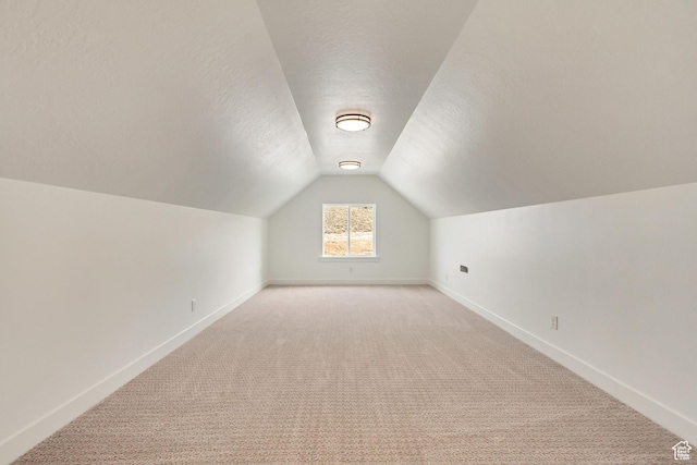 8077 N Bristle Cone Rd, Eagle Mountain, UT 84005 - bonus room featuring light carpet, baseboards, vaulted ceiling, and a textured ceiling