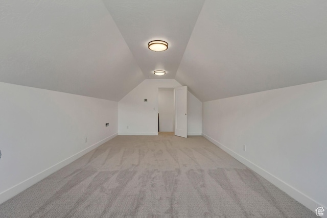 8077 N Bristle Cone Rd, Eagle Mountain, UT 84005 - additional living space featuring baseboards, lofted ceiling, and light carpet