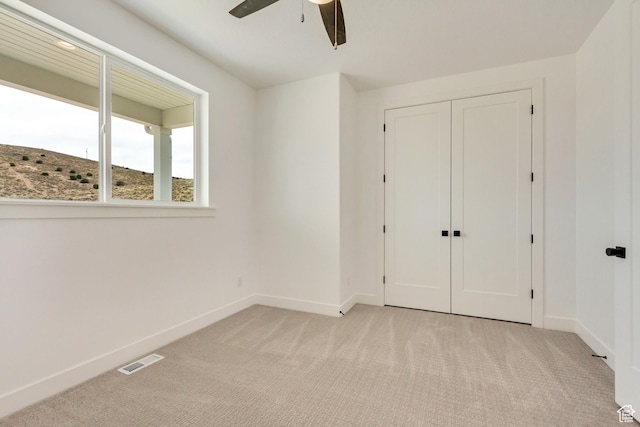 8077 N Bristle Cone Rd, Eagle Mountain, UT 84005 - unfurnished bedroom with a closet, visible vents, baseboards, ceiling fan, and light carpet