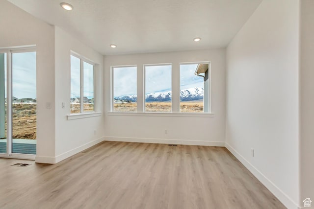 8077 N Bristle Cone Rd, Eagle Mountain, UT 84005 - unfurnished room with baseboards, recessed lighting, visible vents, and light wood-style floors