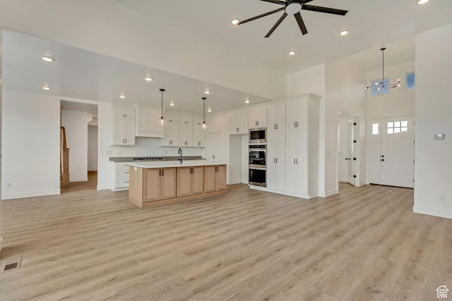 8077 N Bristle Cone Rd, Eagle Mountain, UT 84005 - kitchen with open floor plan, light wood-style flooring, ceiling fan, and visible vents