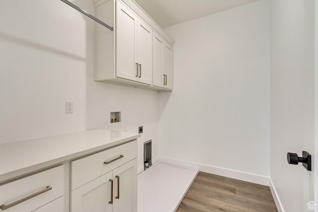 8077 N Bristle Cone Rd, Eagle Mountain, UT 84005 - clothes washing area with washer hookup, electric dryer hookup, light wood-style flooring, baseboards, and cabinet space