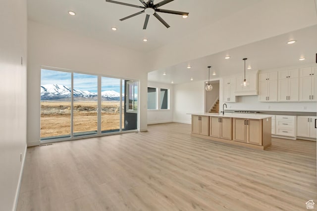 8077 N Bristle Cone Rd, Eagle Mountain, UT 84005 - kitchen with a kitchen island with sink, open floor plan, ceiling fan, and light wood-type flooring