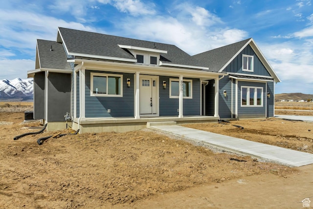 8077 N Bristle Cone Rd, Eagle Mountain, UT 84005 - view of front of house with covered porch, board and batten siding, and a shingled roof