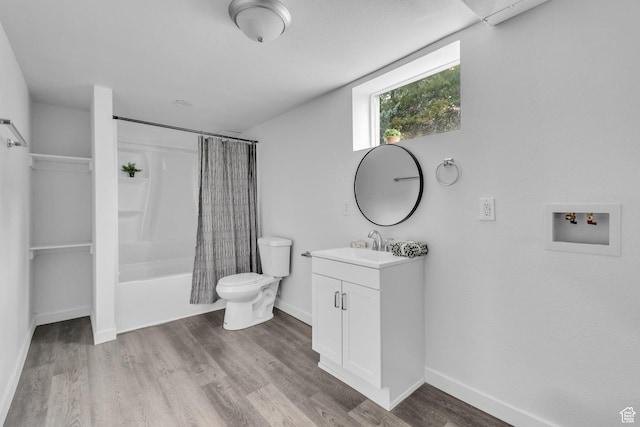 full bathroom with baseboards, wood finished floors, toilet, vanity, and shower / bathtub combination with curtain