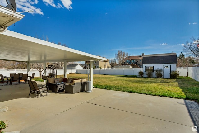 view of patio / terrace featuring an outdoor structure, a fenced backyard, and a storage shed