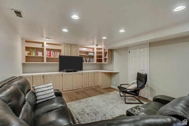 living room with visible vents, recessed lighting, and light wood-type flooring