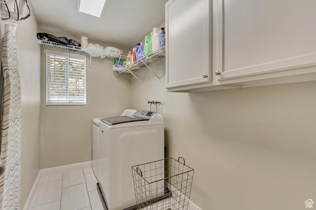 laundry area with baseboards, washing machine and dryer, tile patterned floors, and cabinet space