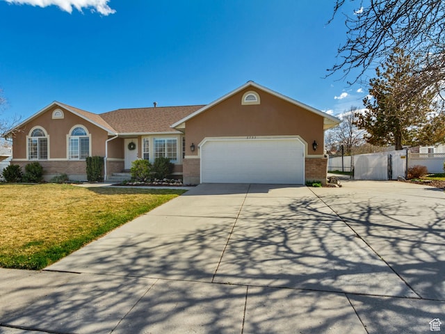 ranch-style house with a garage, driveway, stucco siding, and fence