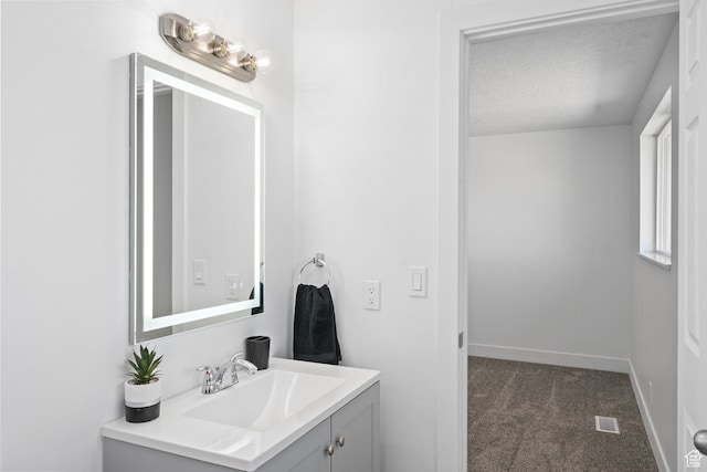 252 W Durfee St, Grantsville, UT 84029 - bathroom with vanity, baseboards, and a textured ceiling