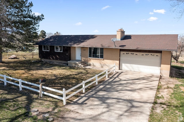 ranch-style home with brick siding, driveway, fence, and an attached garage