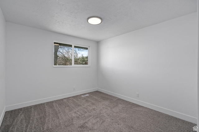252 W Durfee St, Grantsville, UT 84029 - spare room featuring a textured ceiling, baseboards, and dark colored carpet