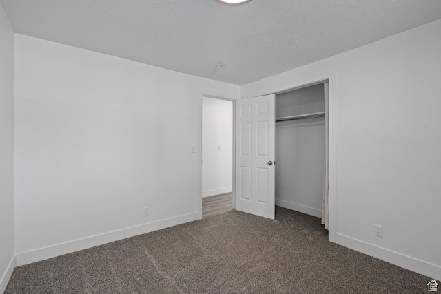 252 W Durfee St, Grantsville, UT 84029 - unfurnished bedroom with dark carpet, baseboards, and a closet