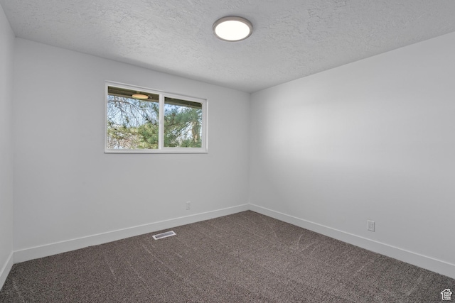 252 W Durfee St, Grantsville, UT 84029 - empty room featuring a textured ceiling, baseboards, and dark carpet