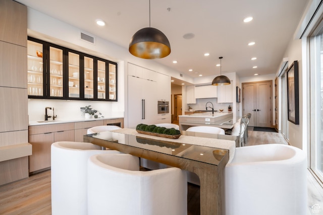 1271 Lowell Ave Unit D201, Park City, UT 84060 - kitchen featuring oven, light wood-style flooring, modern cabinets, and recessed lighting