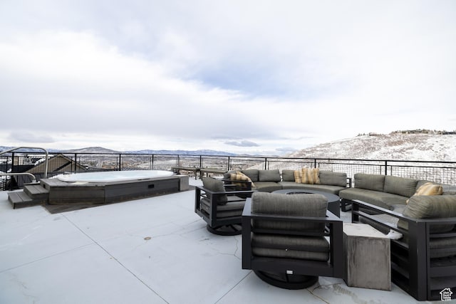 1271 Lowell Ave Unit D201, Park City, UT 84060 - snow covered patio featuring an outdoor hot tub, an outdoor living space, a mountain view, and a patio area