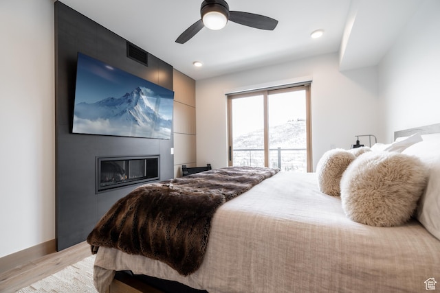 1271 Lowell Ave Unit D201, Park City, UT 84060 - bedroom featuring light wood finished floors, ceiling fan, access to exterior, and a large fireplace